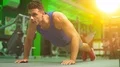 The man push up from the floor in a sport center 4k or 4k+ Resolution