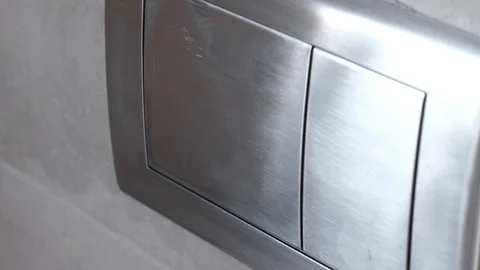 Man push flush button in modern restroom Stock Footage 112360175