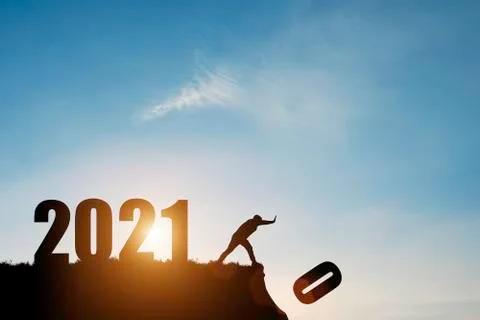 Man push number zero down the cliff where has the number 2021 with blue sky Stock Photos