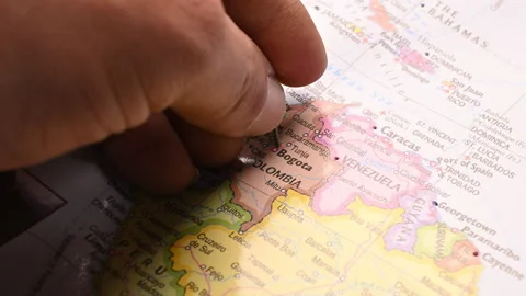Man Push Pin Pointing On  Bogota On World Travel Map Stock Footage 328089573