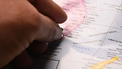 Man Push Pin Pointing On Canberra On World Travel Map Stock Footage 328100057