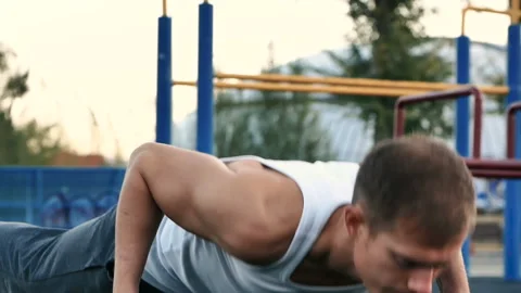Man push-UPS from the floor on the Playground Stock Footage 96714474