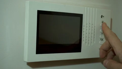 A Man Pushes a Button and Checks Door Step on Video Intercom Stock Footage 129835791