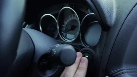 Man pushes button to start an engine in modern car. Stock Footage 78626205