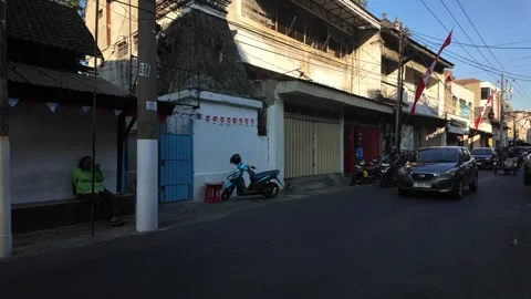Man pushes cart loaded with sacks down street Stock Footage 345144171