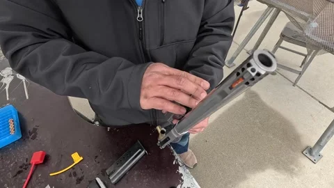 Man pushes ejector rod to quickly empty cylinder of a revolver Stock Footage 259124207