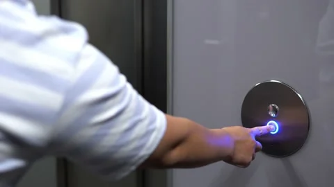 A man pushes an elevator button in a hallway and waits - closeup Video stock 168418776