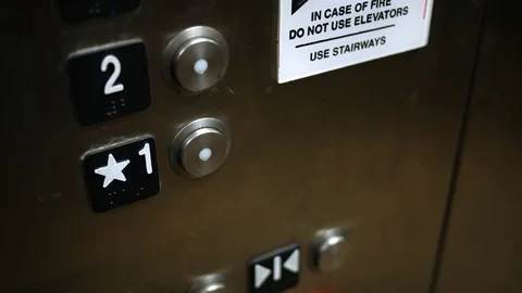 Man pushes a first floor button in modern elevator shaft Stock Footage 83367550