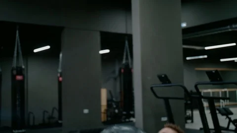 A man Pushes a Heavy Ball in Training, a Guy Works out In the gym, Medball , a Stock Footage 127249921