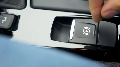 A man pushes the parking brake button Stock Footage 96151182