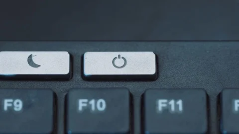 A man pushes power button to turn computer monitor on and off Stock Footage 70369378