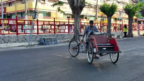 Man pushes rickshaw on paved street Stock Footage 345199301
