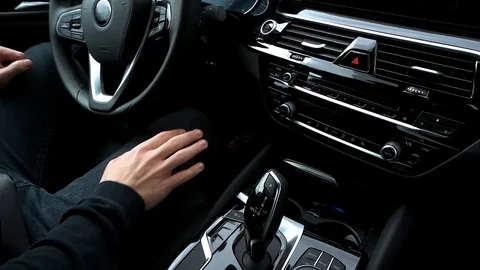 Man pushes start engine button in the car Stock Footage 89935133