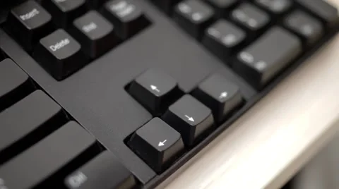 A man is pushing arrow key on keyboard Stock Footage 54354570