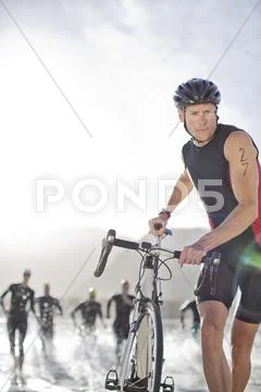 Man Pushing Bicycle On Beach