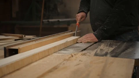 Man pushing board through table saw in workshop Stock Footage 102045039