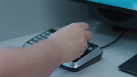 A man pushing buttons and moving a control knob on a digital device Stock Footage 274136254