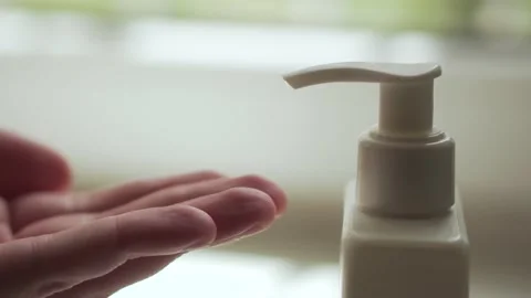 Man pushing dispenser and liquid soap squeezed out to hand, closeup. Stock Footage 131360068