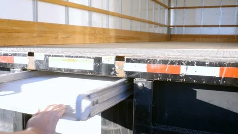Man Pushing In a Metal Ramp on a Moving Truck in 4k Stock Footage 89296502
