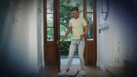 Man pushing open front door with sidelights, entering home bringing dog on leash Stock Footage 333033764