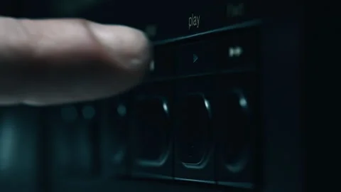 Man pushing play button at retro player in dark room closeup. Hand pressing knob 動画素材 332674523