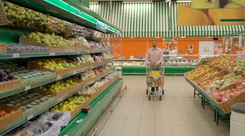 Man pushing shopping trolley in store Stock Footage 63431392