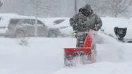 Man Pushing Snowblower In Blizzard Stock Footage
