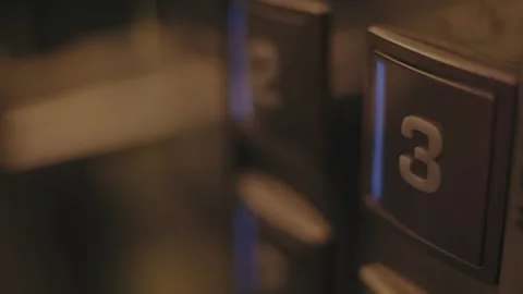 Man pushing the third floor button in an elevator Stock Footage 256910727