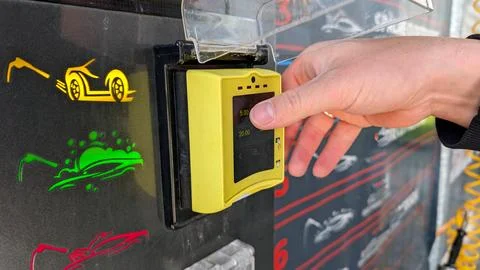 Man Pushing Touchscreen On Payment Terminal At Car Wash Station 스톡 사진