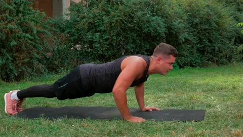 Man pushup exercise outdoor. Fit body push up workout in park Stock Footage 146360671