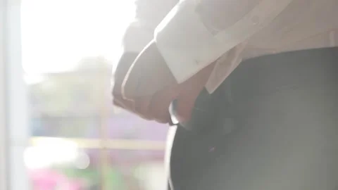 Man put on belt closeup with sun flares Stock Footage 243659815