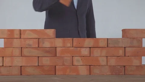 Man put the brick on brick wall Stock Footage 81556562