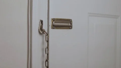 Man put chain on door Stock Footage 76418630