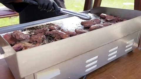 Man put down on a wooden board ready to eat grilled steak meat, male roasted Stock Footage 261432292