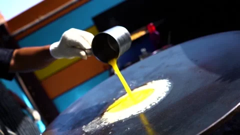 A Man put an Egg Yolks into a Frying Pan with One Hand Stock Footage