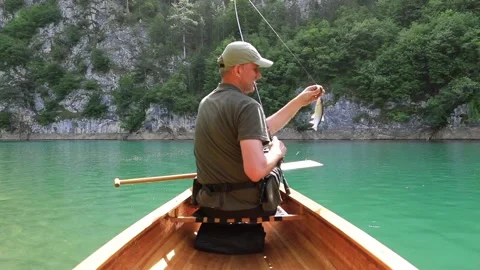 Man put the fish back in the water Stock Footage 276787977