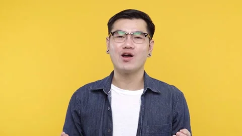 A man put on glasses and denim jacket white t-shirt talking and gesturing on cam Stock Footage 144669380