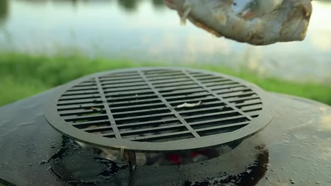Man put hake fish on the grill Stock Footage 136590549