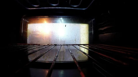 Man put out baking plate from oven Stock Footage 85894993