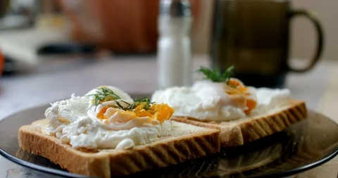 A man put poached eggs on crispy toast Stock Footage 87252085