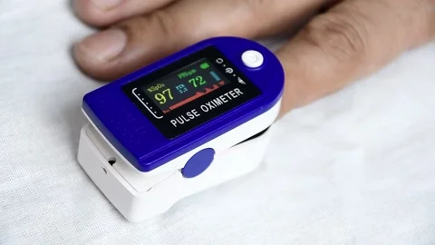 A man put on a pulse oximeter on his finger Stock Footage 145660278