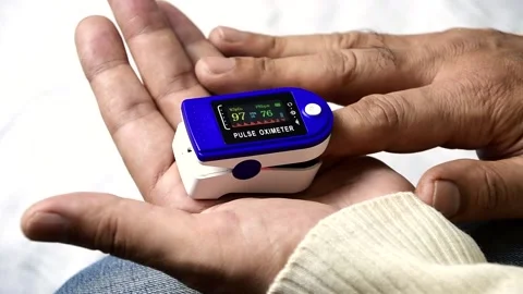 A man put on a pulse oximeter on his finger Stock Footage 145660402