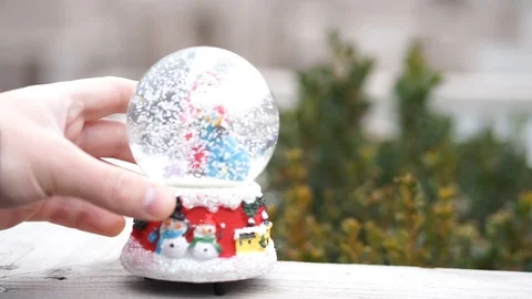 Man put snow globe Stock Footage 98285878