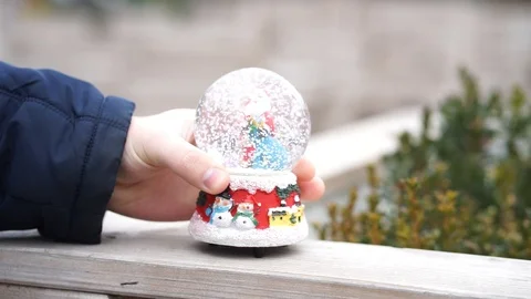 Man put snow globe Stock Footage 98285945