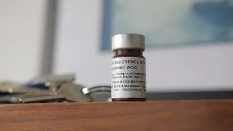 A man put a vial with reference standard material from ascorbic acid also known  Video stock 209712905