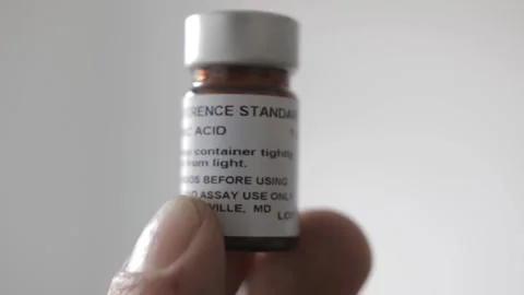 A man put a vial with reference standard material from ascorbic acid also known  Video stock 209712919