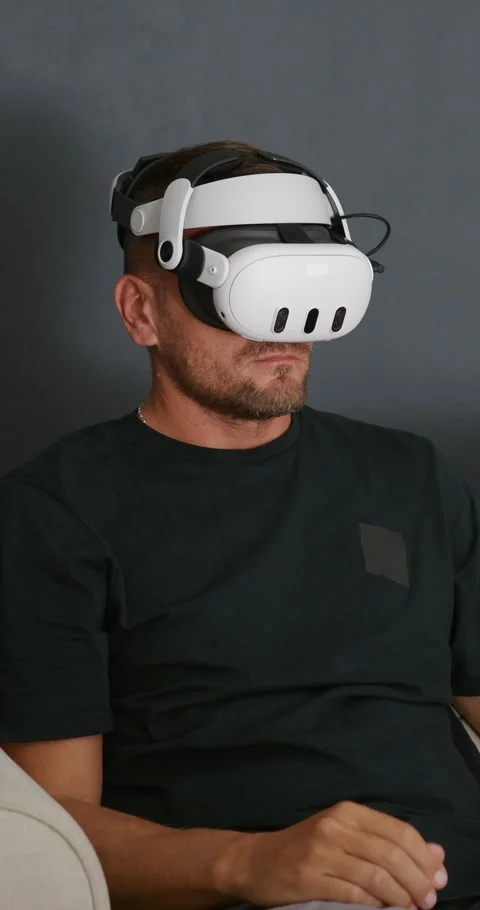 Man put on VR goggles sitting on sofa eating popcorn watching 3d movie. Stock Footage 258879482