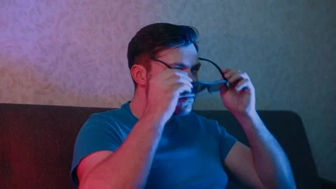 A man puts on 3D glasses and emotionally moves his hands. Stock Footage 131341004