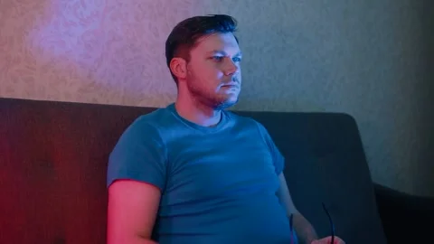 A man puts on 3D glasses and starts switching TV channels. Stock Footage 131460824