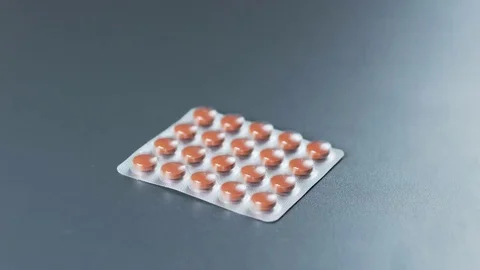 Man Puts and Takes Away Brown Tablets Stock Footage 69219804